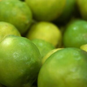 Vibrant green limes closely photographed, showcasing freshness and natural appeal.