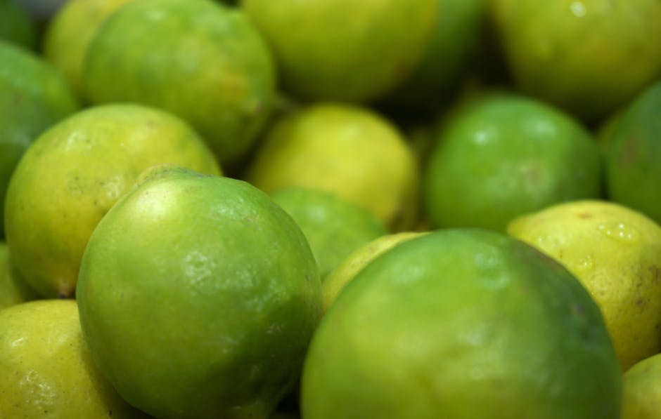 Vibrant green limes closely photographed, showcasing freshness and natural appeal.